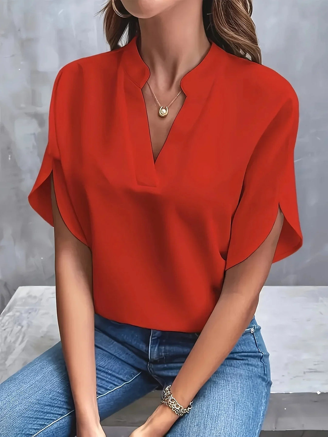 Relaxed styling shot of the Florimay V-neck blouse paired with jeans for a casual weekend look
