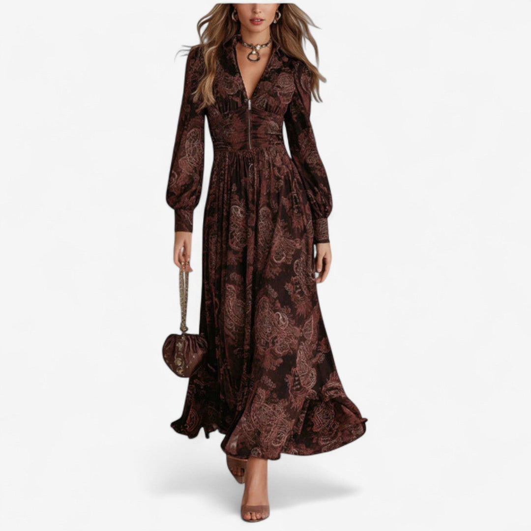 Woman wearing a flowing brown maxi dress with an elegant elongated silhouette, styled casually for daytime wear