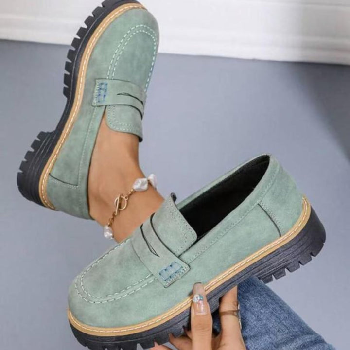 Thalia platform loafers in green displayed on a clean white background, side profile