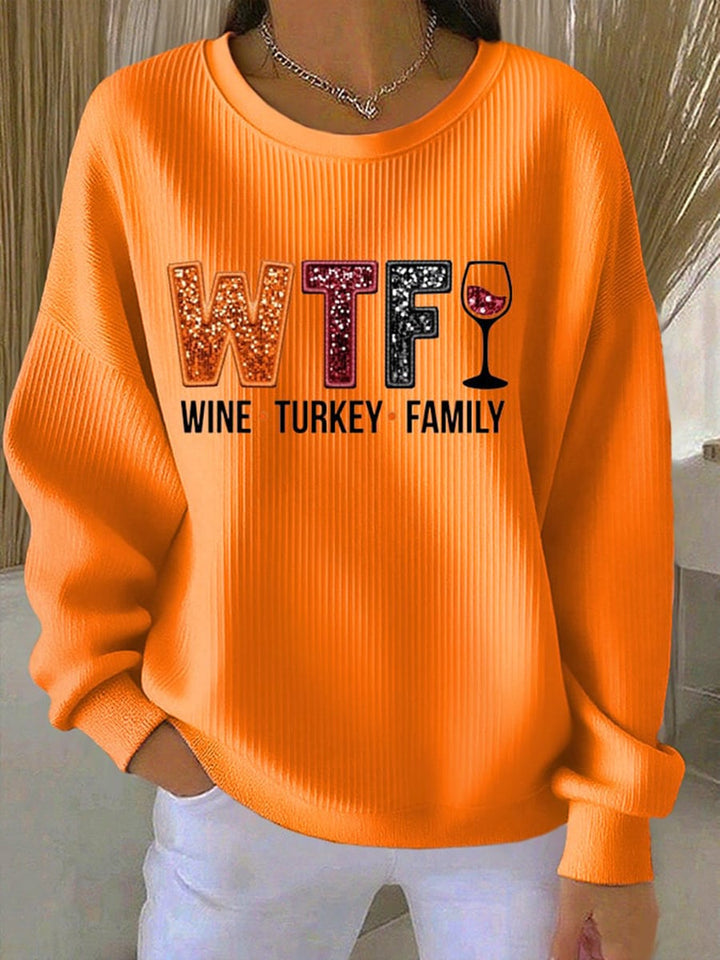 Model wearing an orange relaxed-fit Thanksgiving Spirit Sweatshirt with a festive seasonal graphic print