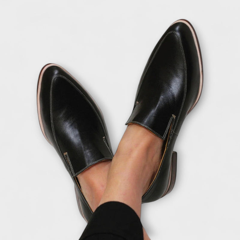 Theodora women's black slip-on loafers shown from a front three-quarter angle on a clean white background