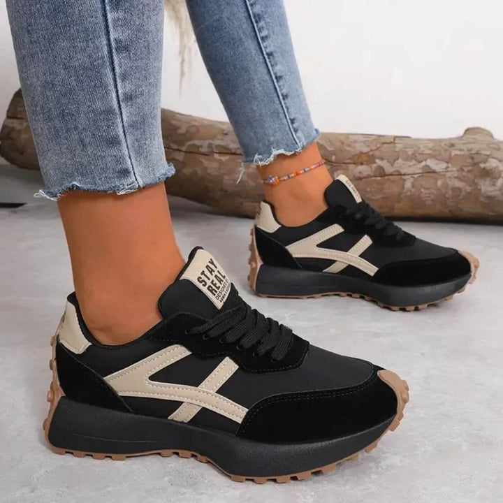 Front view of slip-resistant orthopedic sneakers in neutral colorway showing cushioned sole and breathable upper