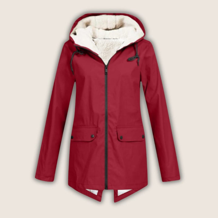 Woman wearing a red ThermaShell windproof waterproof rain jacket with adjustable hood, front view