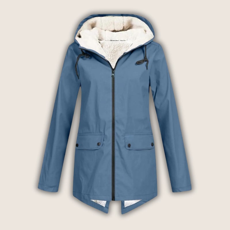 Woman in black ThermaShell rain jacket layered over casual outfit, smiling outdoors