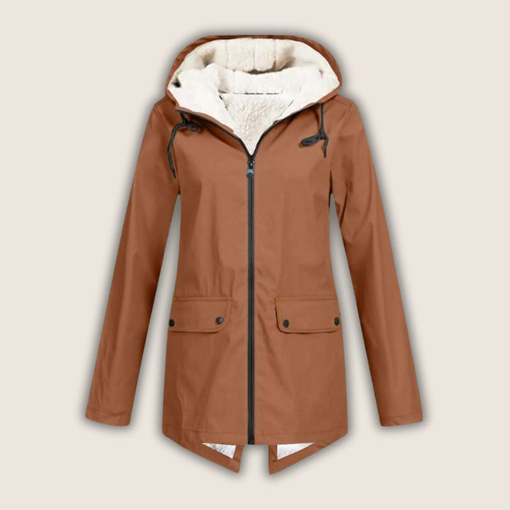 ThermaShell rain jacket in burnt orange on model, three-quarter view showing fit and length