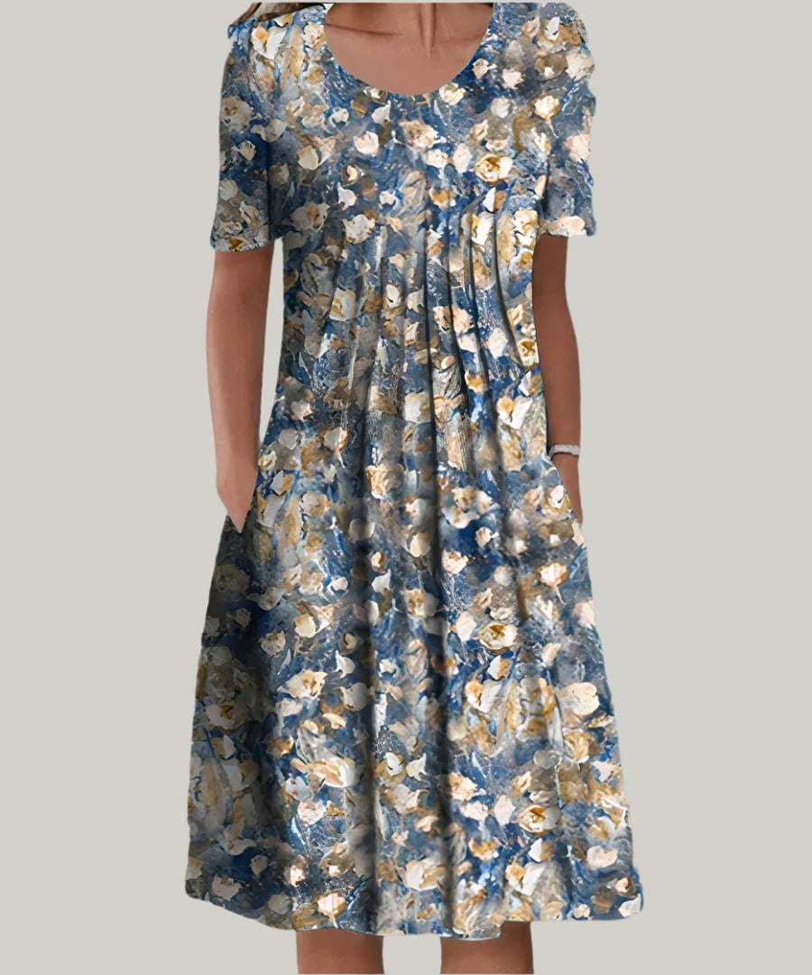 Woman styling the Tina elegant dress in White with Yellow print paired with sandals for a casual daytime look