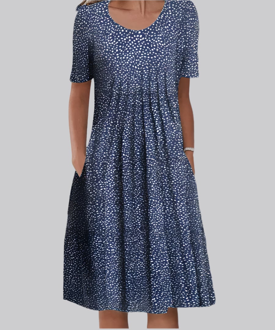 Close-up detail of the Tina elegant dress fabric in Blue Polka Dots, highlighting the soft airy material and flowing design