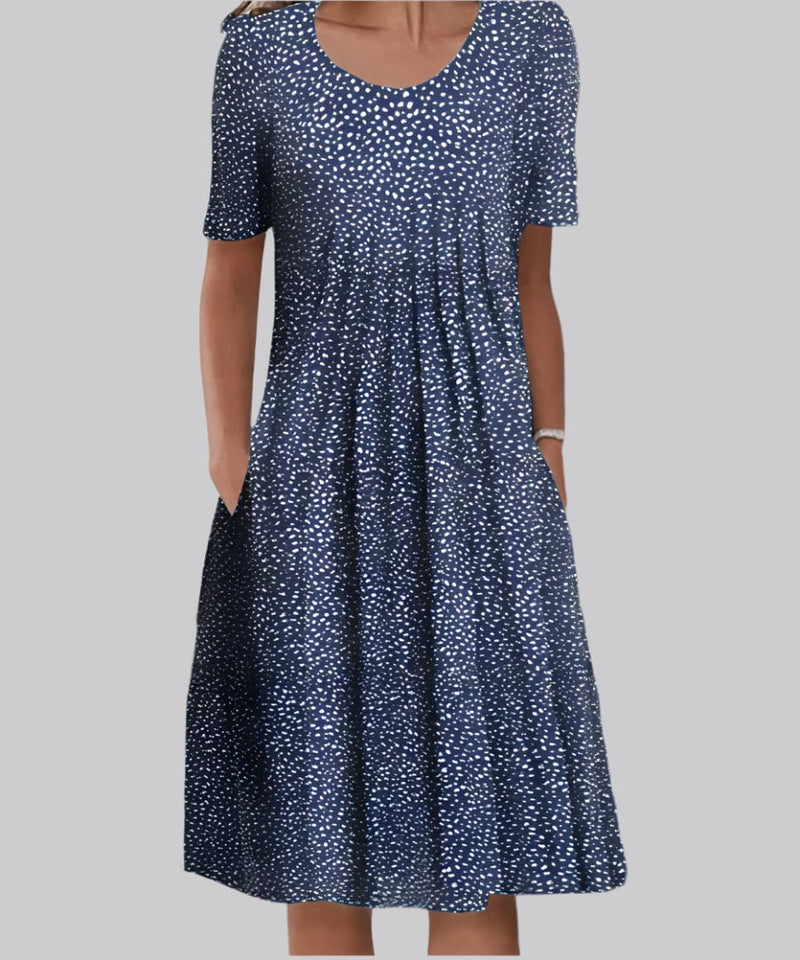 Close-up detail of the Tina elegant dress fabric in Blue Polka Dots, highlighting the soft airy material and flowing design