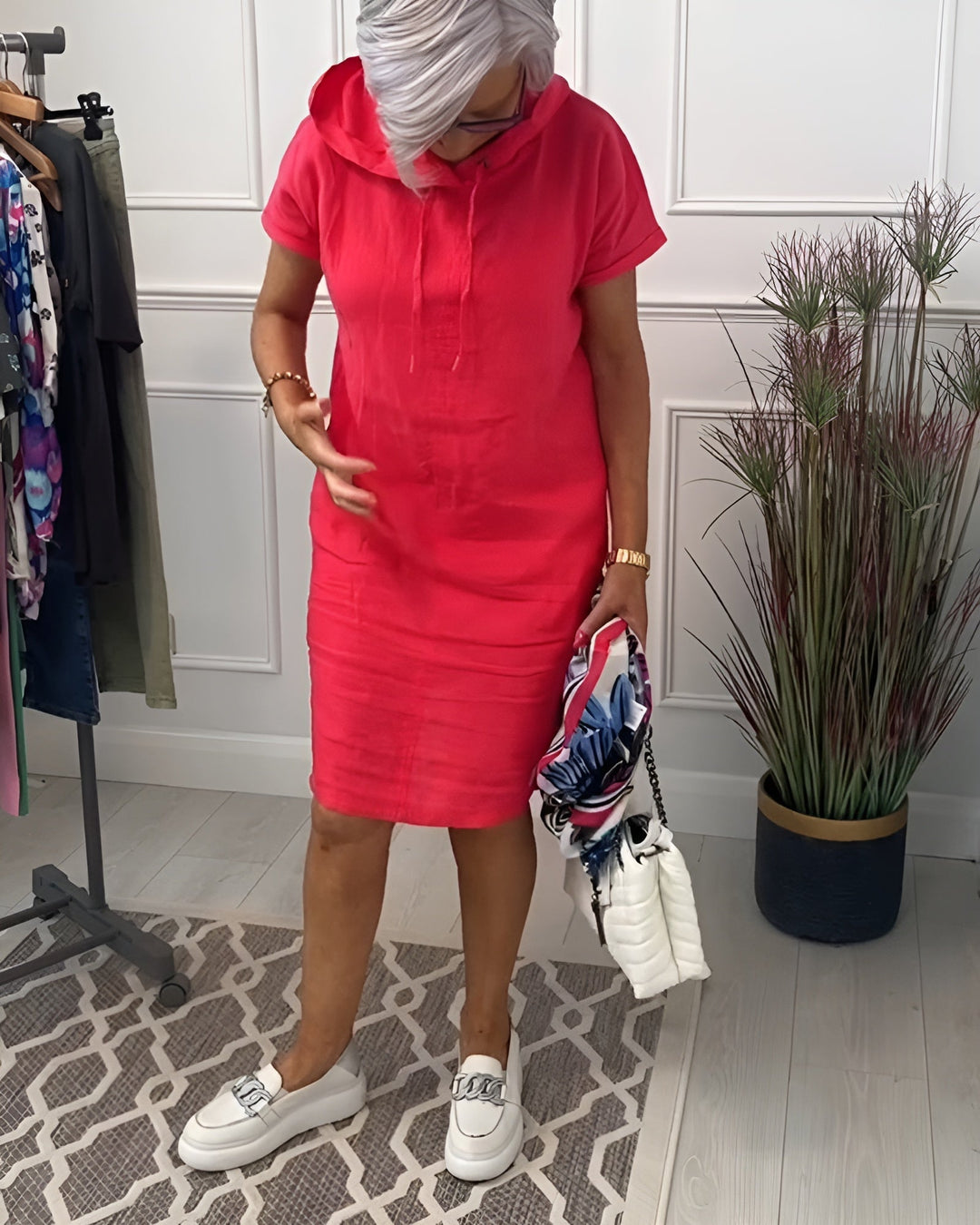 Model in a black hoodie midi dress showing the relaxed fit and below-the-knee length