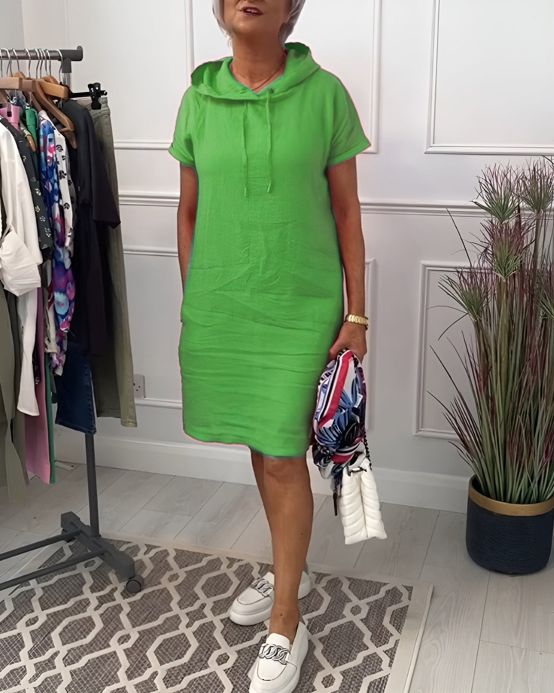 Model posing in the blue hoodie midi dress, front three-quarter view