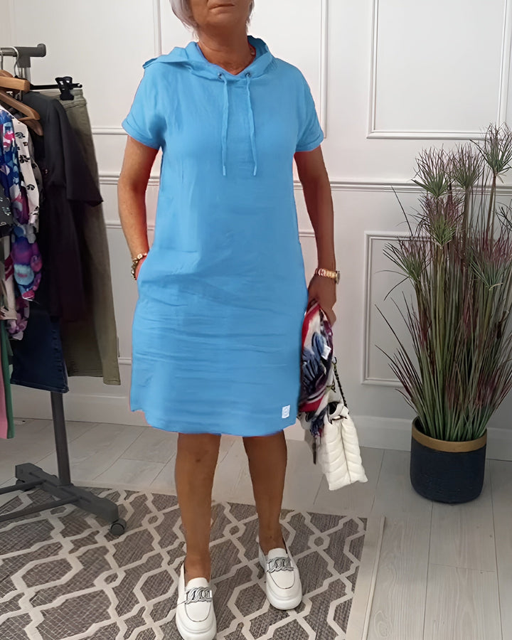 Model in the black hoodie midi dress styled with casual footwear