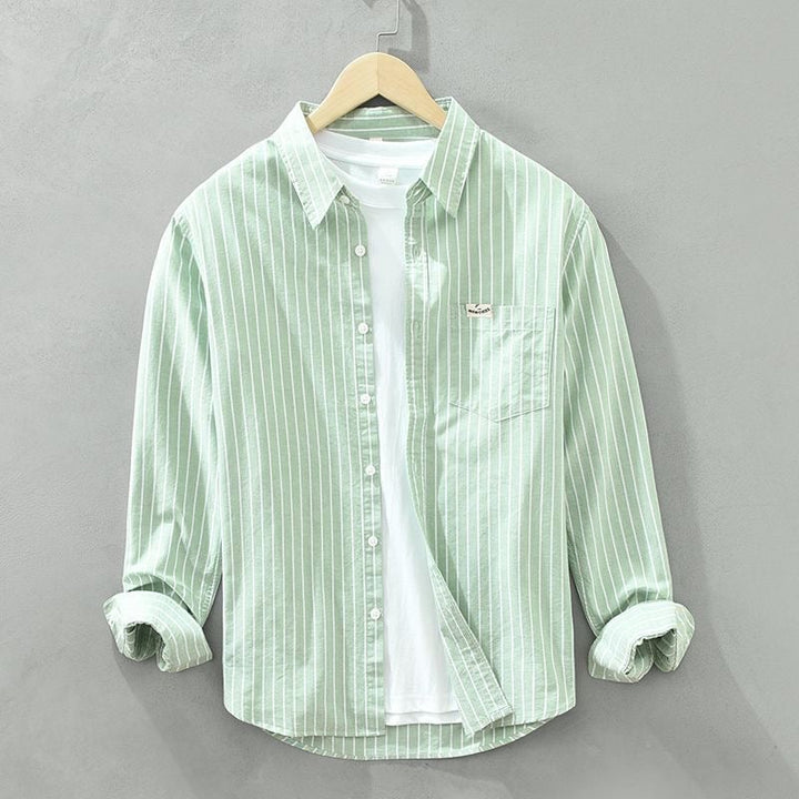 Side detail of striped casual shirt showing lightweight breathable fabric and rolled sleeves
