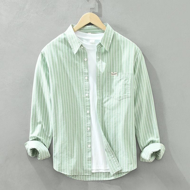 Side detail of striped casual shirt showing lightweight breathable fabric and rolled sleeves