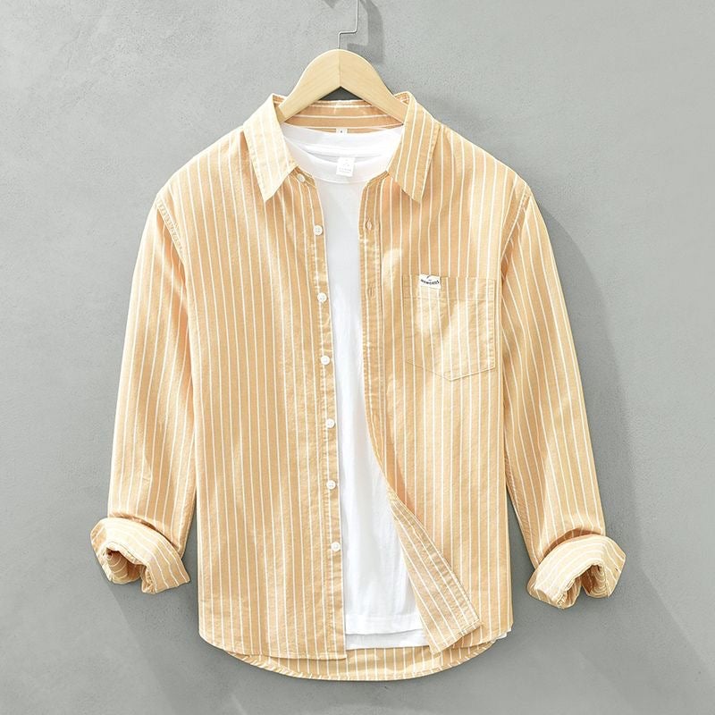 Striped casual shirt styled open over a white tee for a laid-back weekend outfit