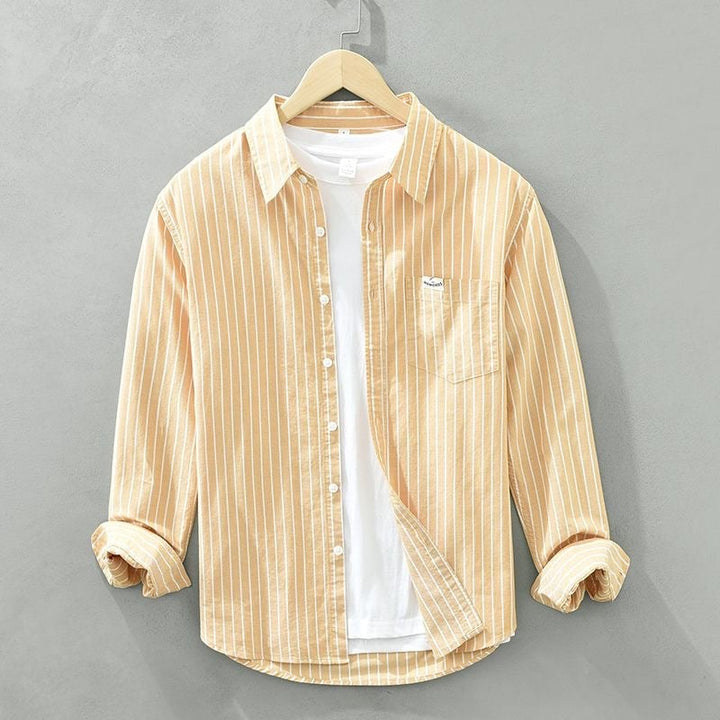 Striped casual shirt styled open over a white tee for a laid-back weekend outfit