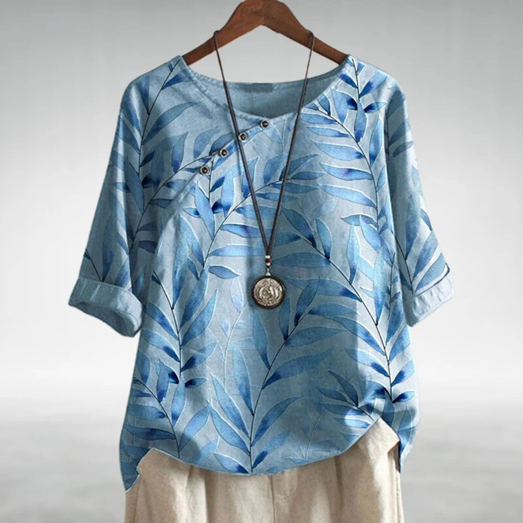 Woman wearing a relaxed chic blouse with asymmetric button closure in a casual daytime setting