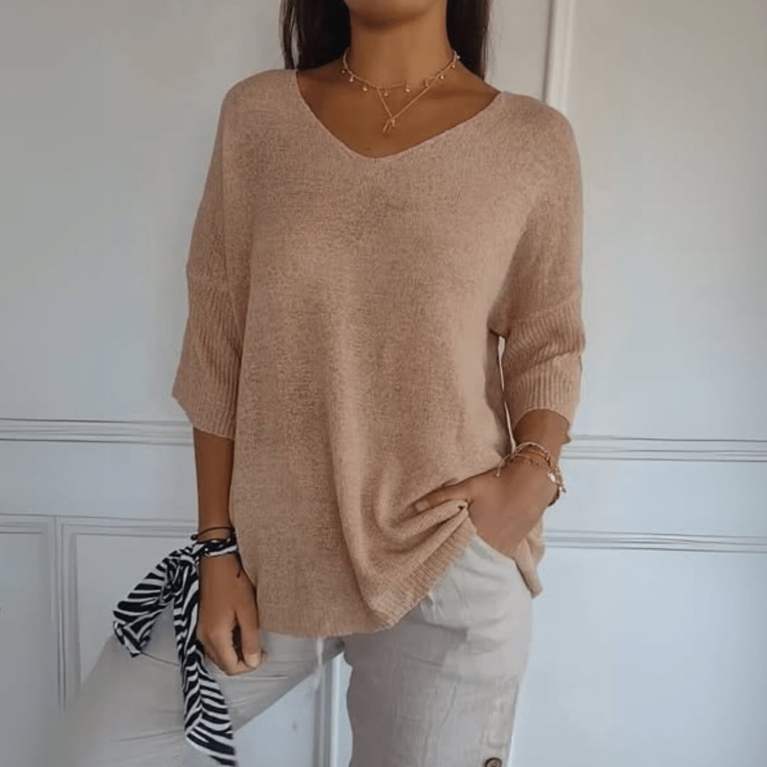 Close-up of a V-neck knit top showing soft fabric texture and flattering neckline detail