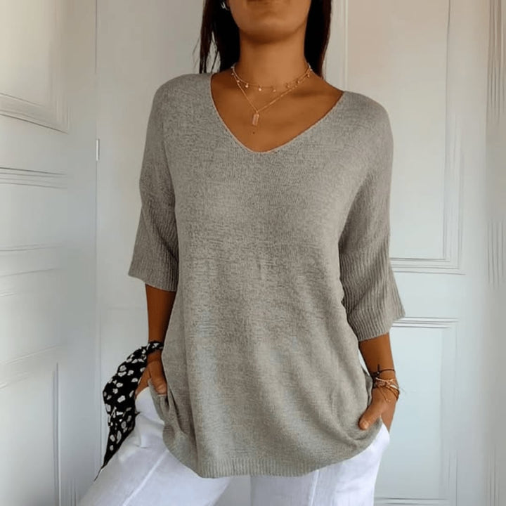 Front view of Toni V-Neck Knit Top in black showing relaxed fit and elegant V-neckline
