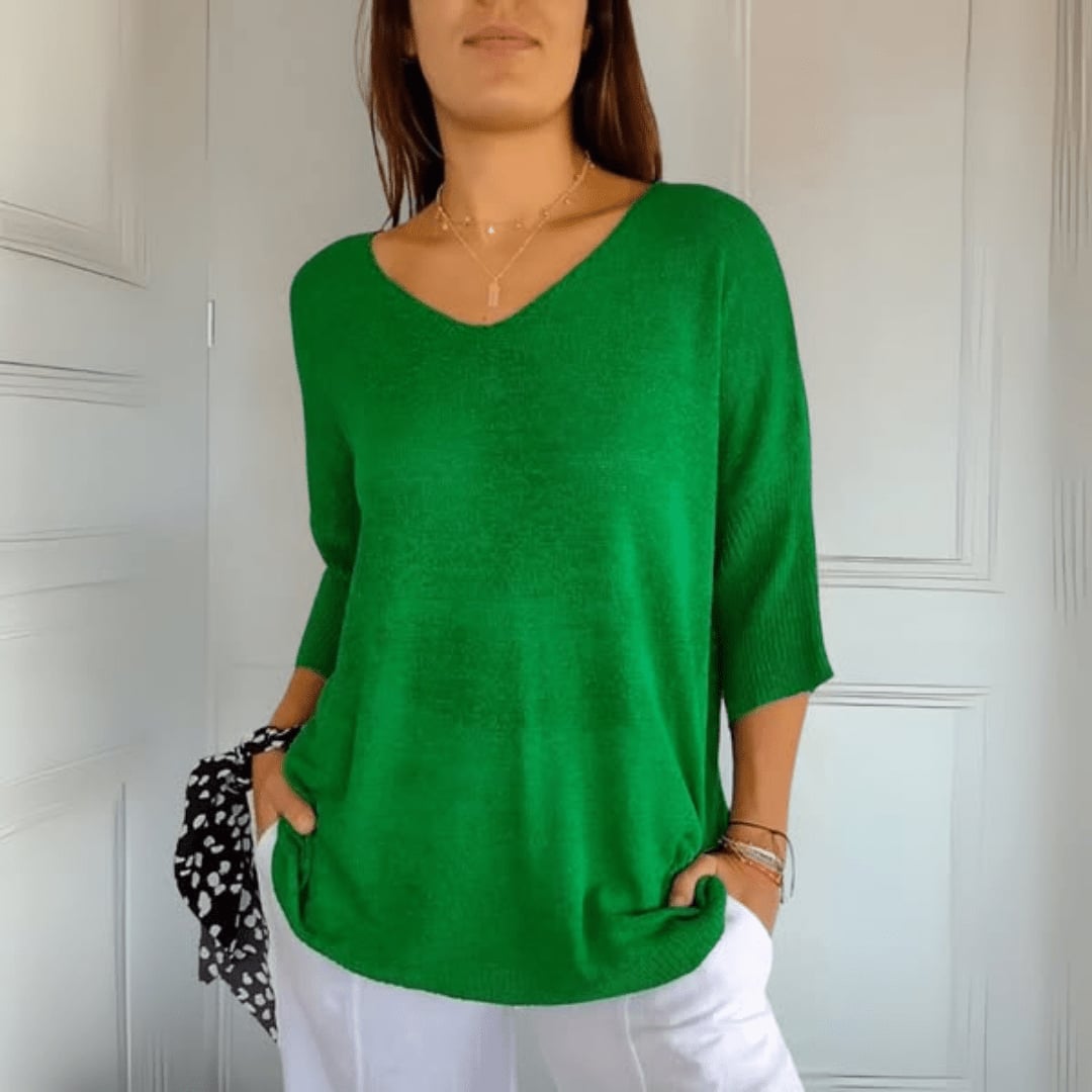 Flat lay of Toni V-Neck Knit Top in purple on a neutral background