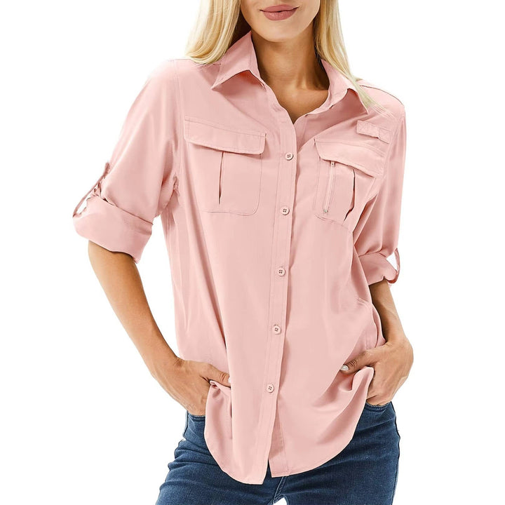 Woman wearing a pink UPF 50 roll-up sleeve safari hiking shirt with dual chest pockets and flip-up collar