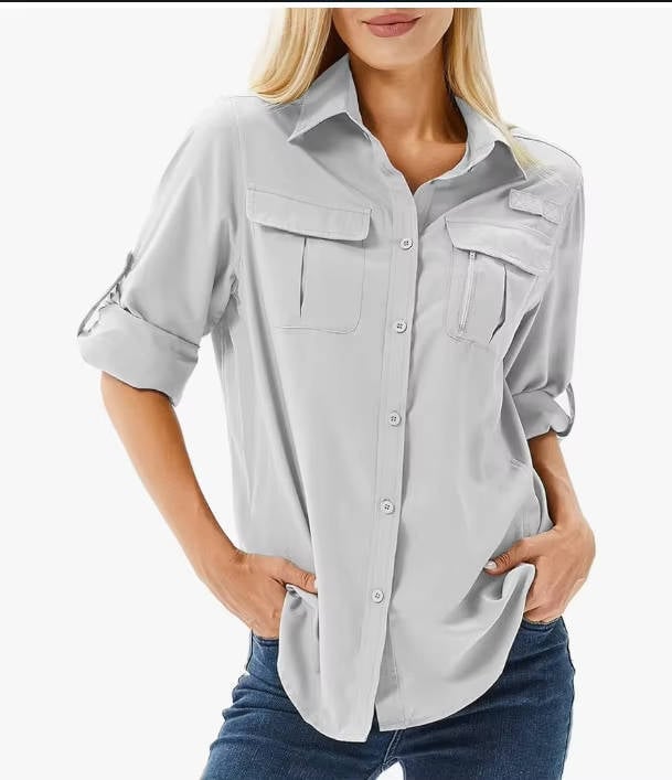 Front view of a light gray women's UPF 50 button-down hiking shirt with roll-up sleeves
