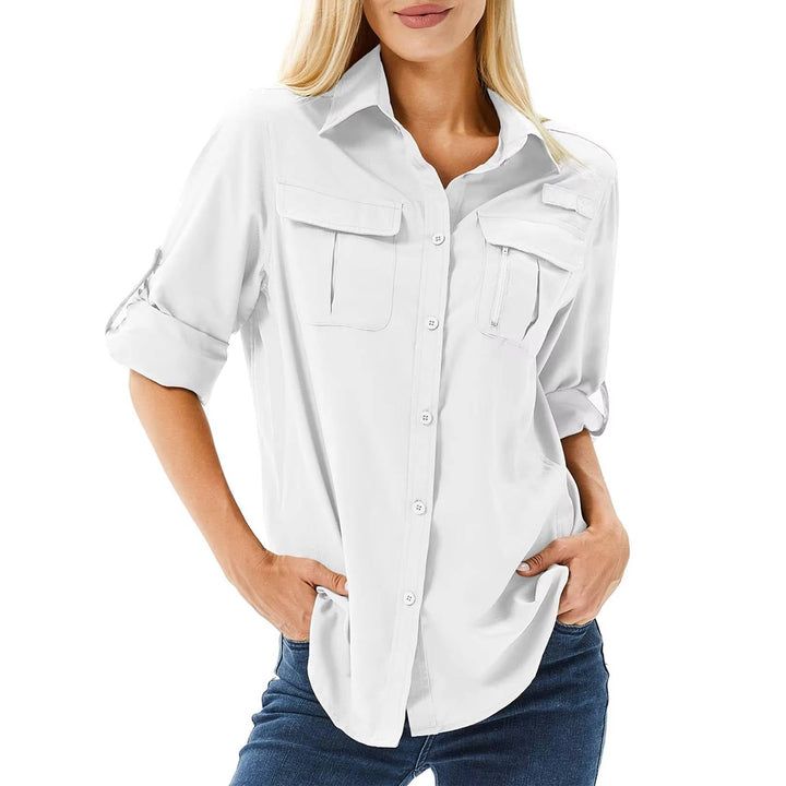 Woman on a trail wearing a white UPF 50 convertible sleeve safari shirt with chest pockets