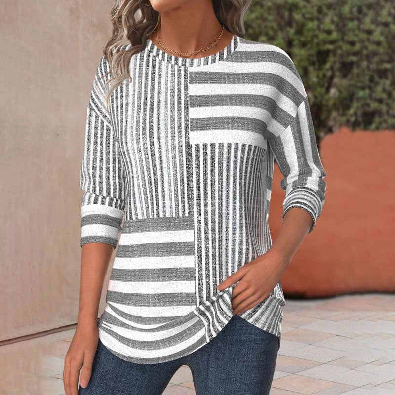 Woman wearing a lightweight striped blouse with three-quarter sleeves in a relaxed, flattering fit