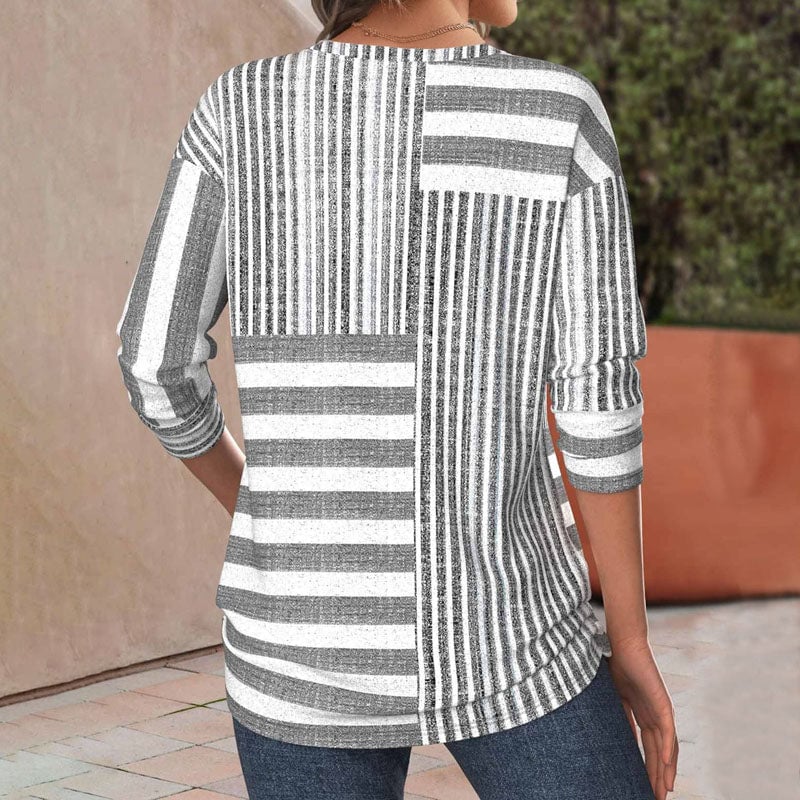 Close-up detail of a soft striped comfort blouse showing smooth fabric drape and three-quarter sleeve length