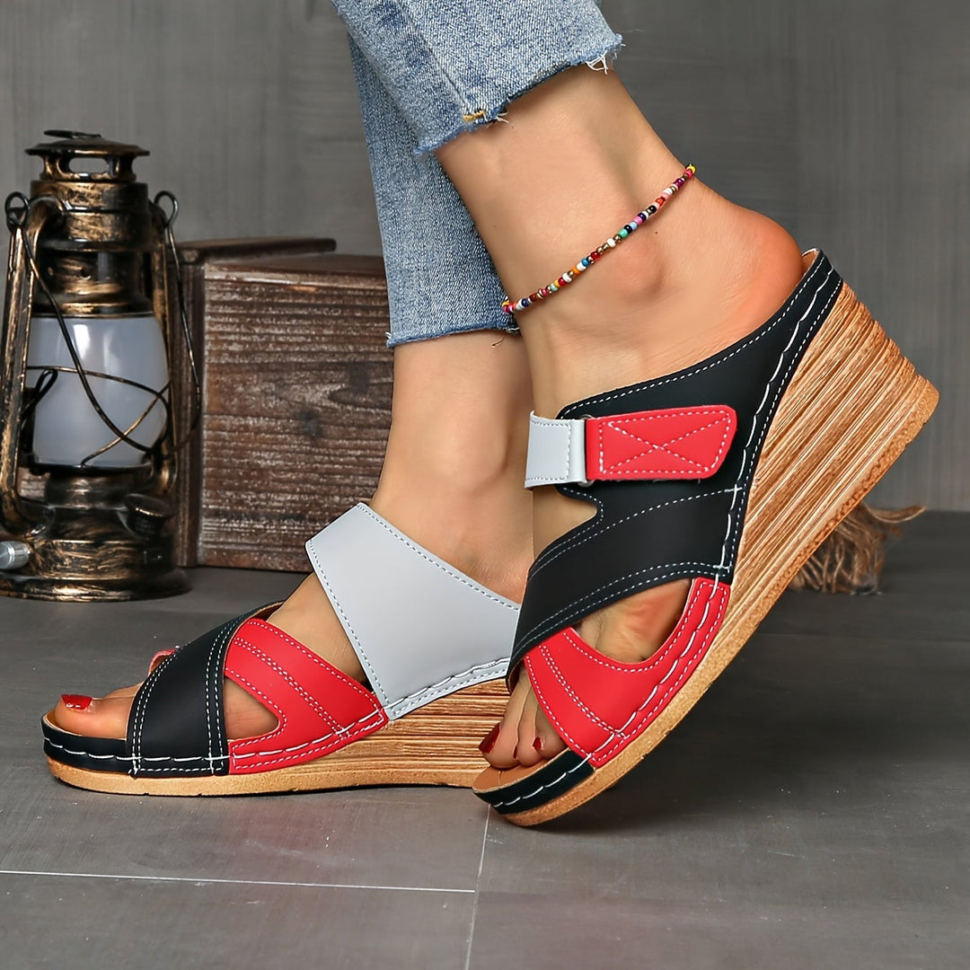 Tulip wedge slides in sky blue pink colorway styled on a flat surface