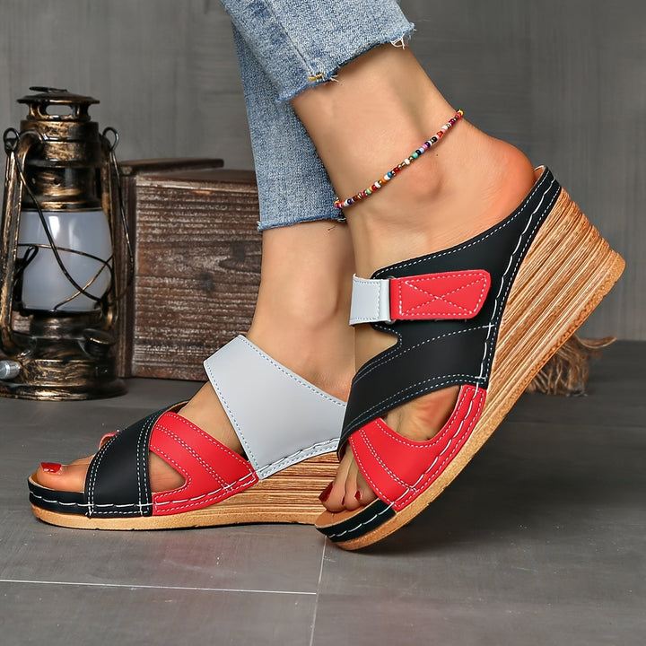 Tulip wedge slides in sky blue pink colorway styled on a flat surface