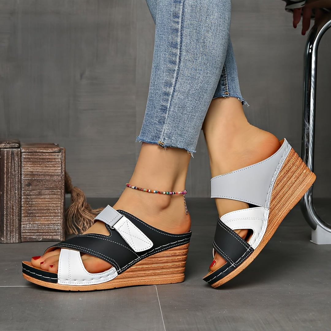 Angled view of Tulip wedge slides in sky blue pink highlighting the wedge height