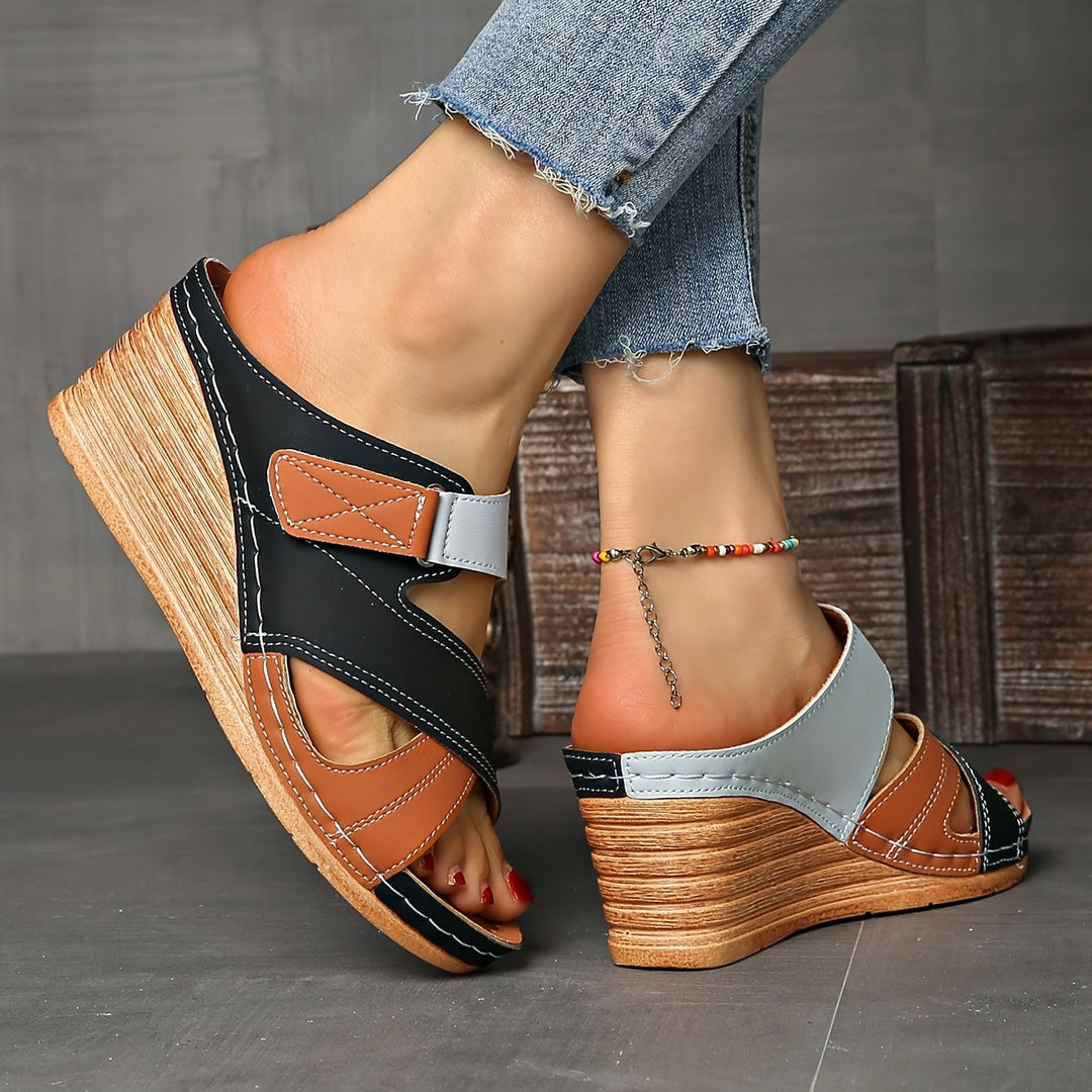 Side profile of Tulip wedge slides in black brown showing sole construction