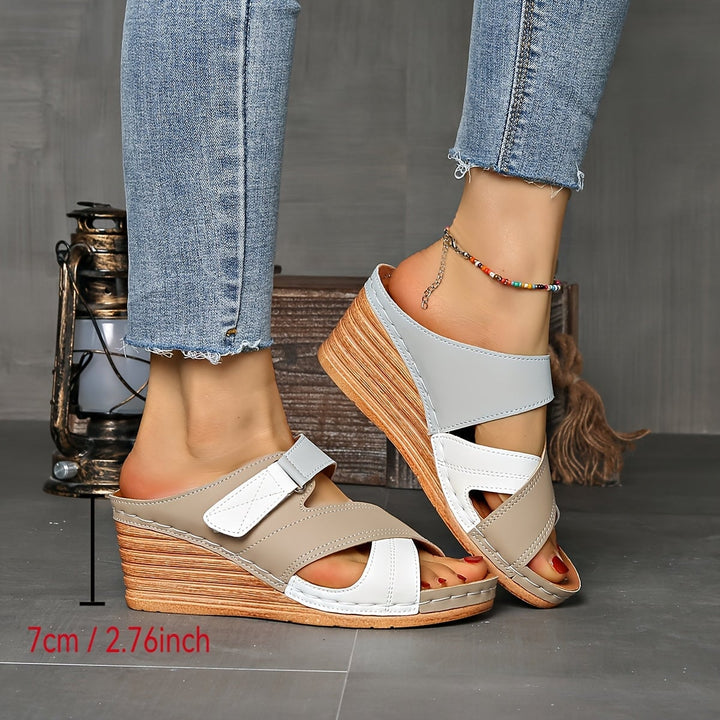 Close-up of black and red colorblock detailing on Tulip wedge slides