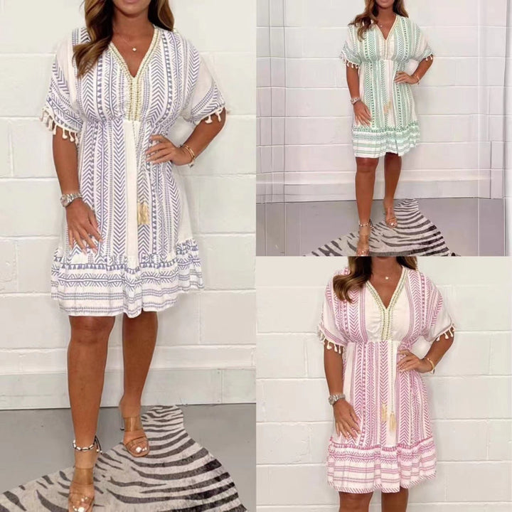Flat lay of boho tassel mini dress showing full geometric print pattern and tassel details