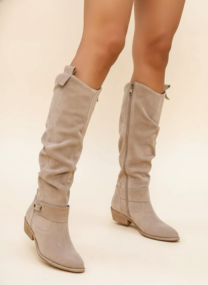 Woman wearing elegant Valencia boots in a neutral tone, styled with casual everyday outfit
