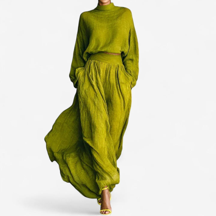 Woman wearing the Valencia green dress with a flattering silhouette and elegant detailing, front view