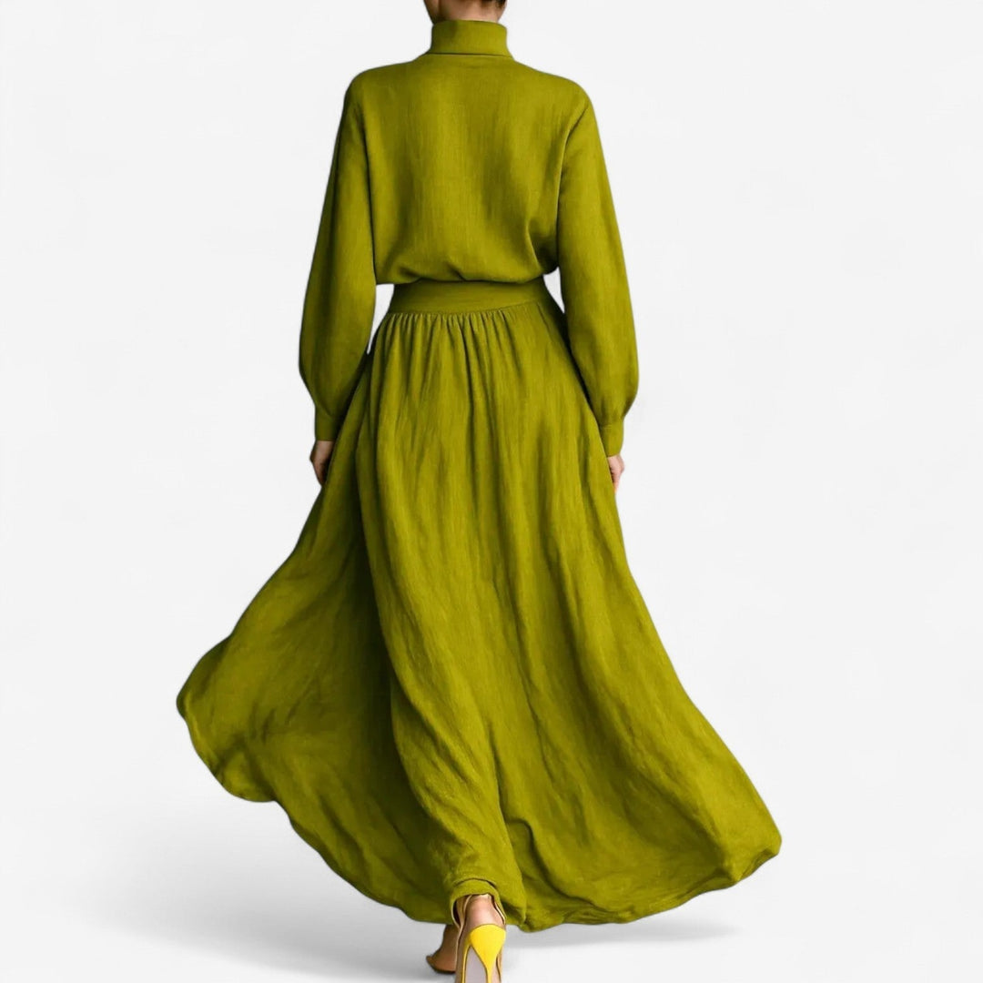 Close-up detail of the Valencia green dress showing refined fabric texture and polished finishing