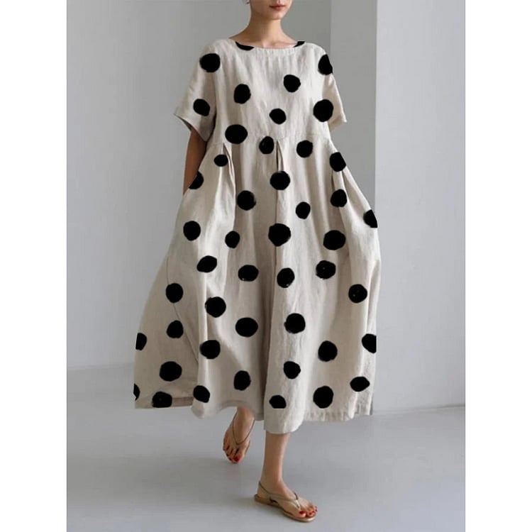 White long casual dress with black polka dot print, relaxed fluid silhouette, shown in full length front view
