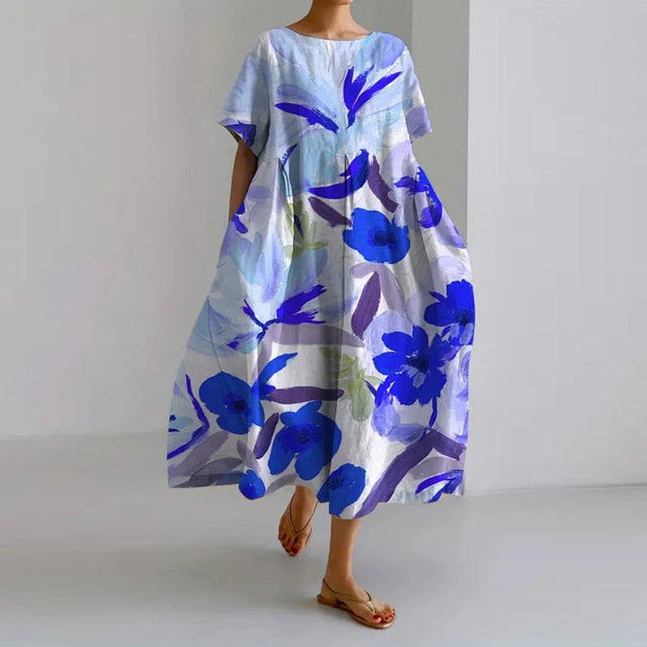 Close-up detail of the Valentina dress showing the vibrant artistic floral print and soft lightweight fabric