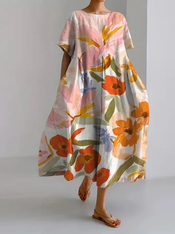 Woman wearing the Valentina floral summer dress in a relaxed flowing silhouette with short sleeves and a vibrant floral print