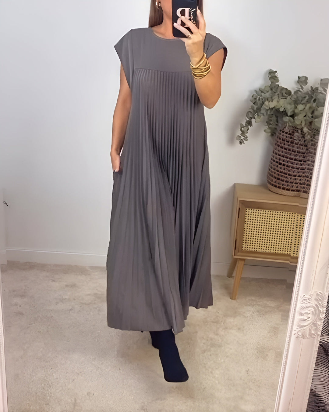 Side view of the Valentina pleated dress showing graceful pleat detail and flattering fit