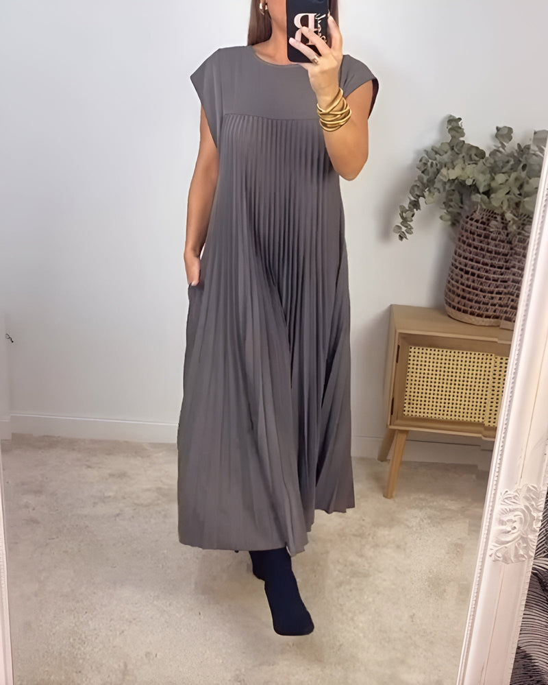 Side view of the Valentina pleated dress showing graceful pleat detail and flattering fit