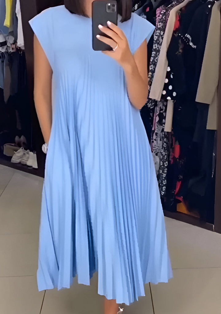 Valentina pleated dress styled with heels for an evening occasion