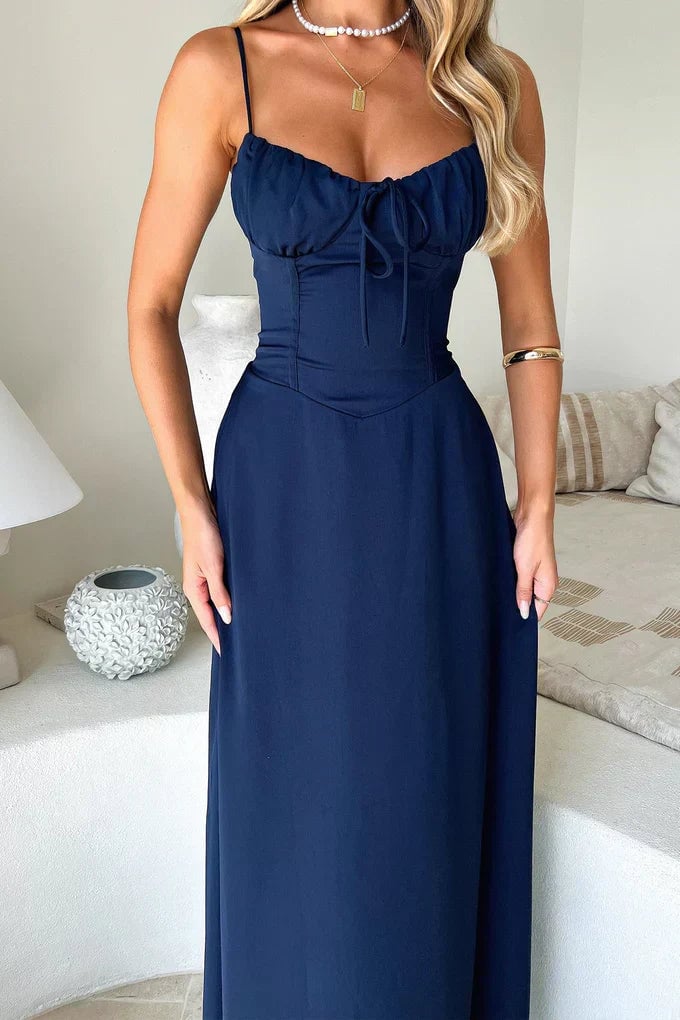 Model wearing Valentina wrap maxi dress in white at an outdoor evening setting
