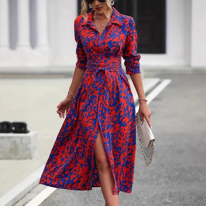 Woman wearing the Valentina abstract-print belted midi shirt dress in orange, styled with heels against a neutral background