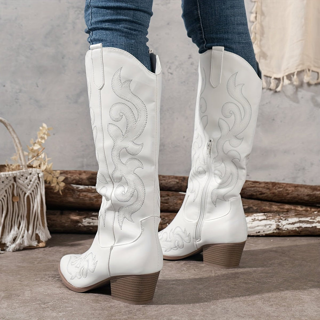 Woman wearing white insulated mid-calf Winter Grace boots against a clean background