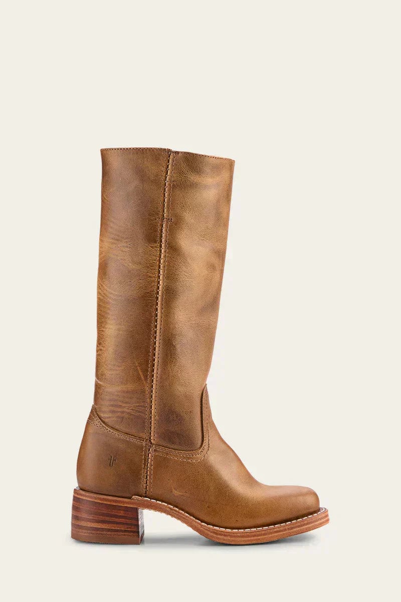 Model wearing brown slim-fit knee-high boots with skinny jeans