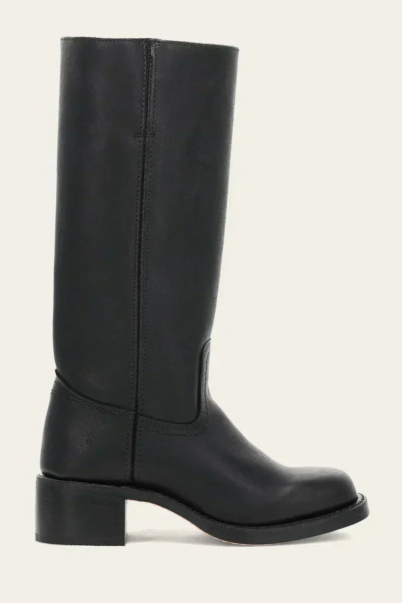 Model walking in black slim-fit knee-high boots, full-length shot