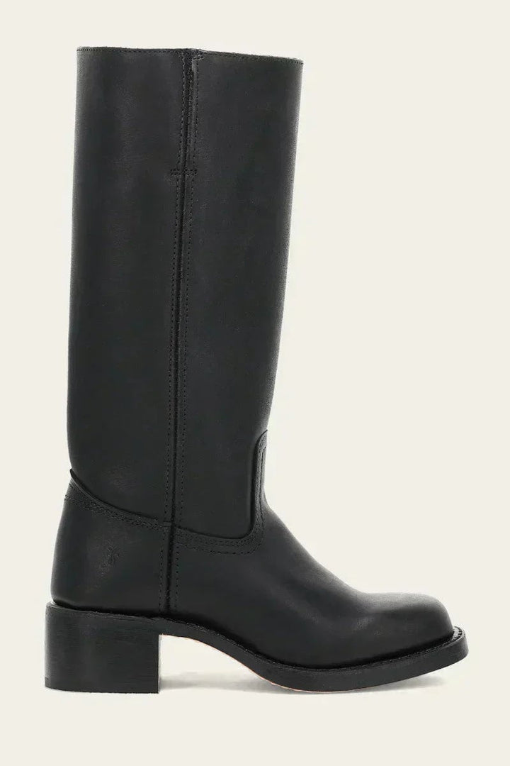 Model walking in black slim-fit knee-high boots, full-length shot