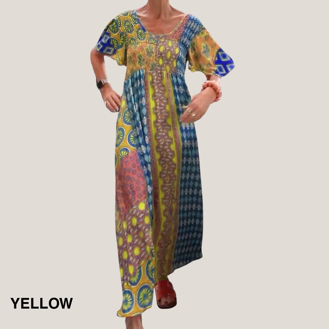 Back view of the elegant paisley midi dress in yellow showing the round neckline and flowing silhouette